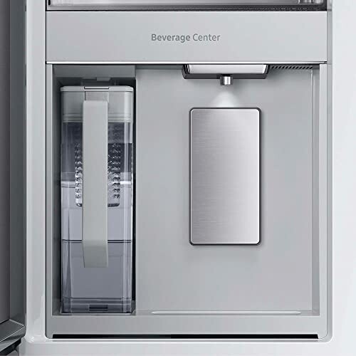 Refrigerator beverage center with water dispenser and pitcher.